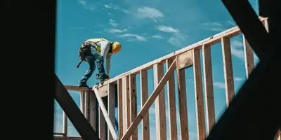 construction worker in hard hat on building frame