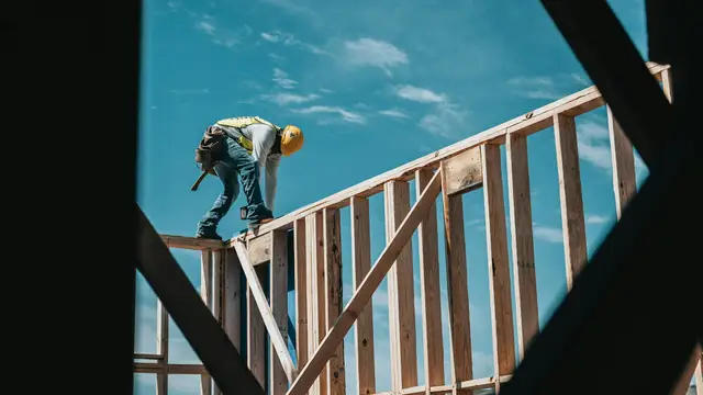 construction worker in hard hat on building frame