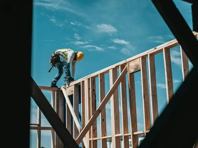 construction worker in hard hat on building frame