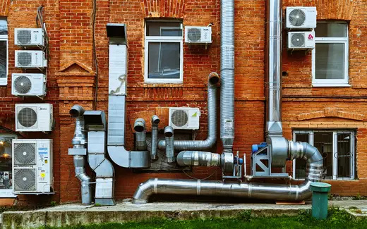 a building with a bunch of pipes on the side of it