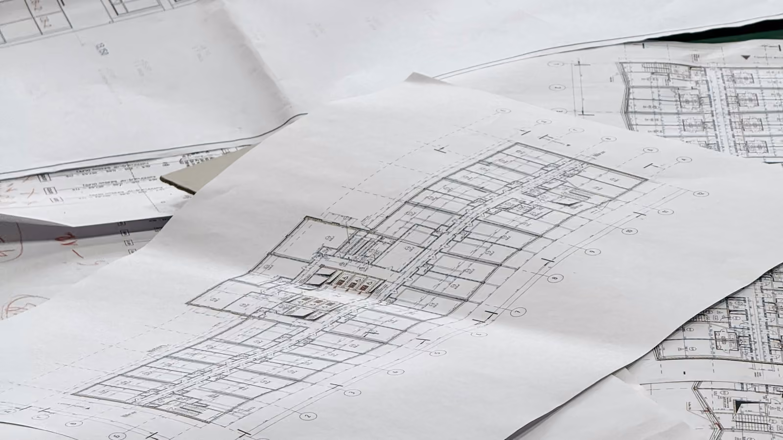Architectural blueprints spread out on a surface.